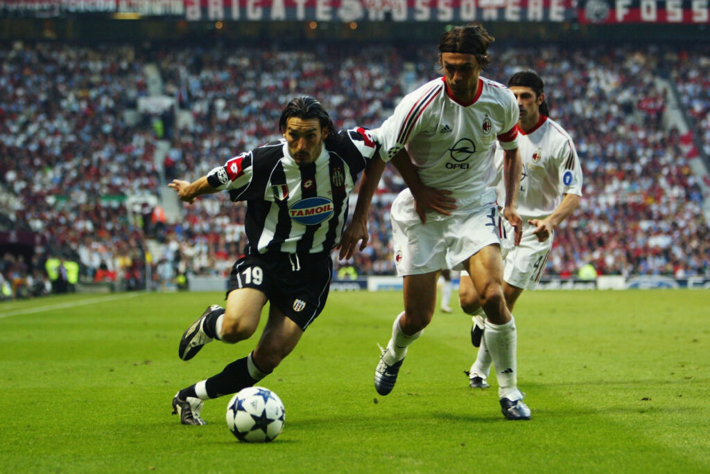Paolo Maldini of AC Milan chases Gianluca Zambrotta of Juventus